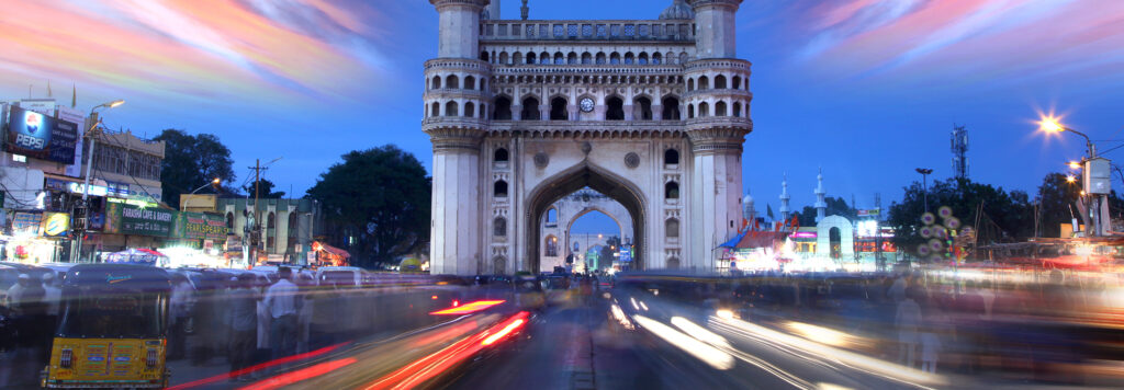 Busy street in India, at the sunset, where car lights show as light streaks